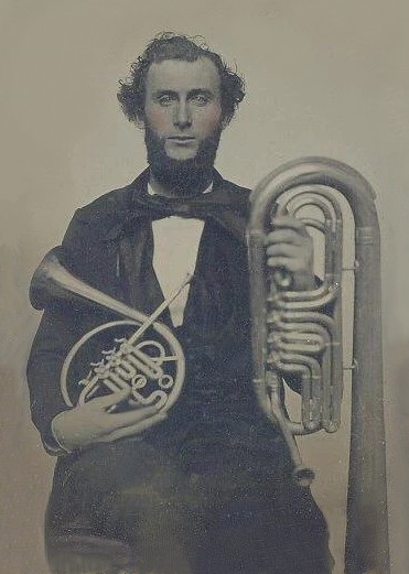 Amberotype of Isaac Fiske holding two of his instruments